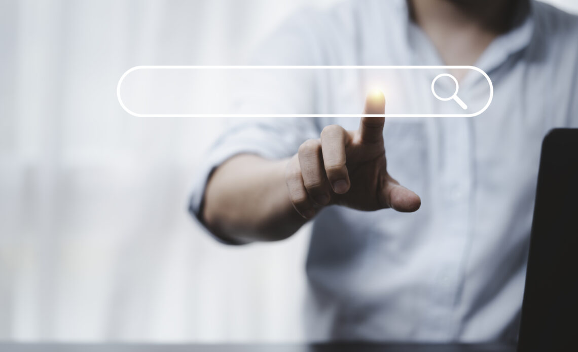 hand touching with search icon for search engine optimisation or
